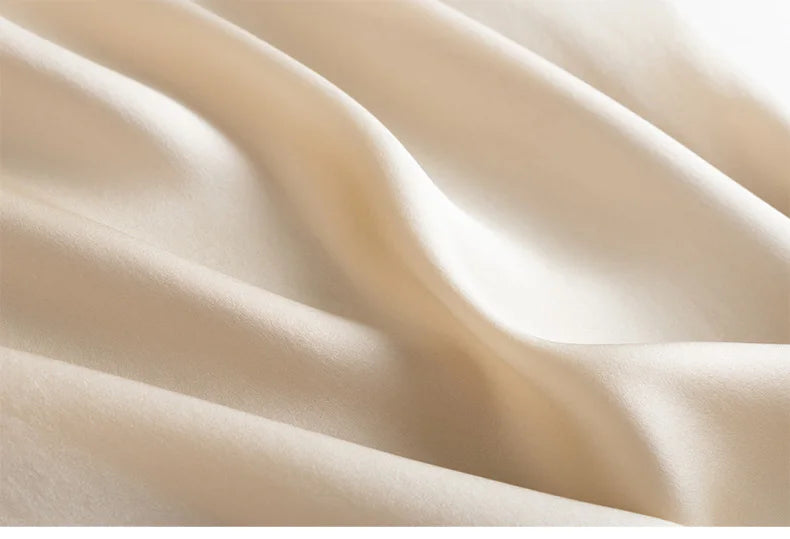 Close-up of beige silk fabric with soft folds