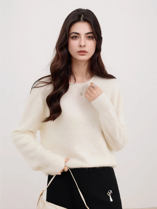 A woman wears a white wool-cashmere-silk knit sweater with a Vcrew neck and long sleeves.