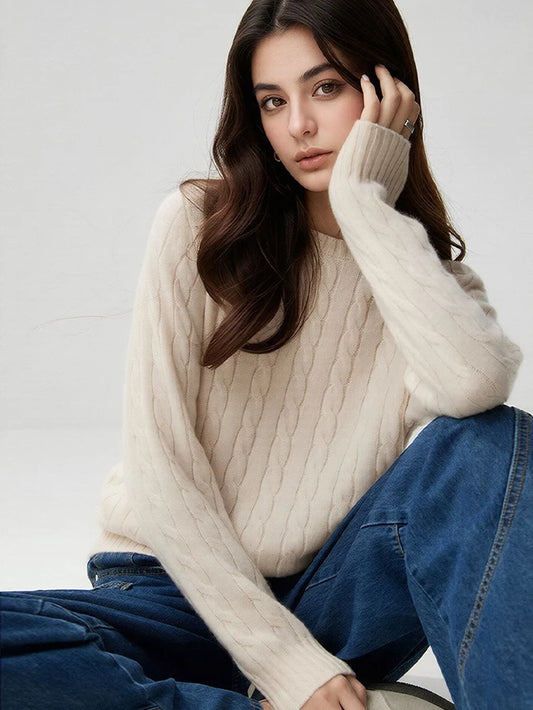 A woman wears a wool-cashmere beige sweater 