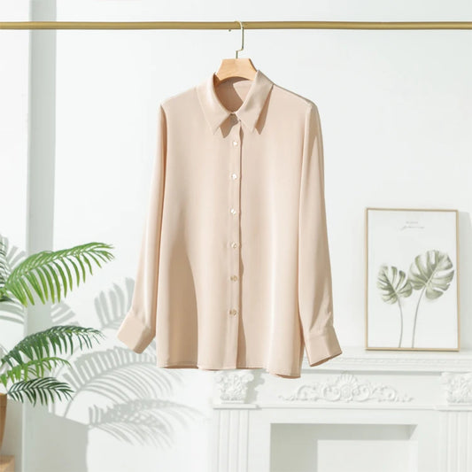 Beige long-sleeve button-front shirt on a wooden hanger.